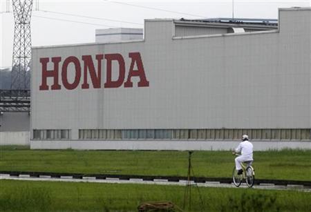 A worker rides a bicycle past a Honda auto parts manufacturing plant in Foshan, Guangdong province A worker rides a bicycle past a Honda auto parts manufacturing plant in Foshan, Guangdong province