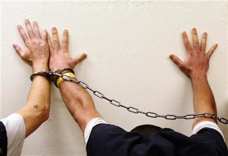 Prisoners place their hands on a wall as they are brought to jail by Orange County sheriff's deputies in Fullerton Prisoners place their hands on a wall as they are brought to jail by Orange County sheriff's deputies in Fullerton
