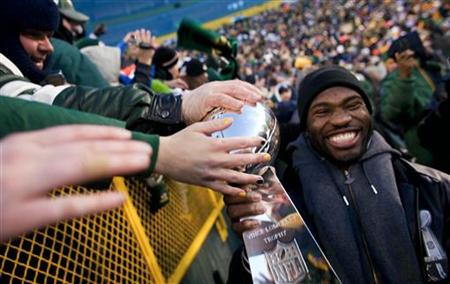 NFL Super Bowl Champions Green Bay Packers' Nick Collins carries the Super Bowl Trophy on a victory lap during the "Return To TitleTown Cele NFL Super Bowl Champions Green Bay Packers' Nick Collins carries the Super Bowl Trophy on a victory lap during the "Return To TitleTown Cele