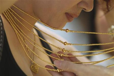 Customer tries on a gold necklace at a gold shop in Hanoi Customer tries on a gold necklace at a gold shop in Hanoi