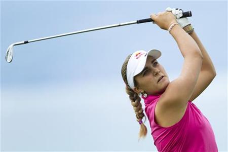 Thompson of the U.S. hits her second shot on the 5th hole during the third round of the Evian Masters golf tournament Thompson of the U.S. hits her second shot on the 5th hole during the third round of the Evian Masters golf tournament