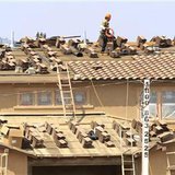 A worker lays shingles as construction continues on a residential home in Carlsbad A worker lays shingles as construction continues on a residential home in Carlsbad