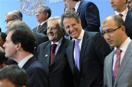 ECB Governor Trichet and U.S. Treasury Secretary Geithner smile as they gather for a group photo during the World Bank/IMF Annual Meetings i ECB Governor Trichet and U.S. Treasury Secretary Geithner smile as they gather for a group photo during the World Bank/IMF Annual Meetings i