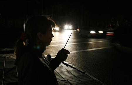A woman listens to news on the radio during a blackout in Vina del Mar city