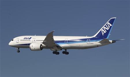 A 787 Dreamliner flies over Boeing Commercial Airplanes manufacturing facilities at Paine Field, Everett, Washington during the jetliner's c A 787 Dreamliner flies over Boeing Commercial Airplanes manufacturing facilities at Paine Field, Everett, Washington during the jetliner's c