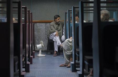 Stockbrokers monitor share prices during a trading session at the Karachi Stock Exchange Stockbrokers monitor share prices during a trading session at the Karachi Stock Exchange