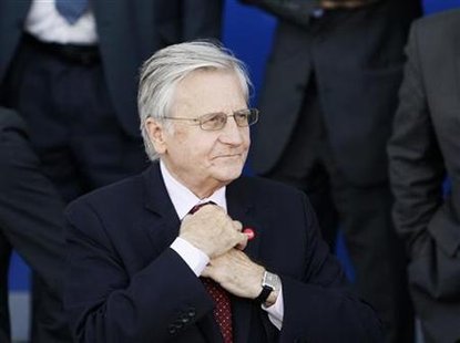 ECB governor Trichet adjusts his tie prior to a family photo taking session at an ECOFIN informal meet in Wroclaw ECB governor Trichet adjusts his tie prior to a family photo taking session at an ECOFIN informal meet in Wroclaw