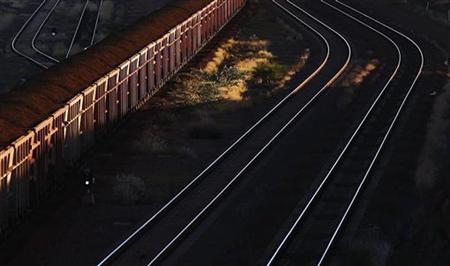 A train loaded with iron ore travels towards the Rio Tinto Parker Point iron ore facility in Dampier