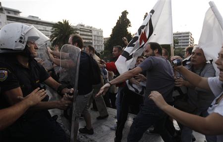 Riot policemen try to disperse protesters during a rally against the government's plans for new austerity measures in Athens
