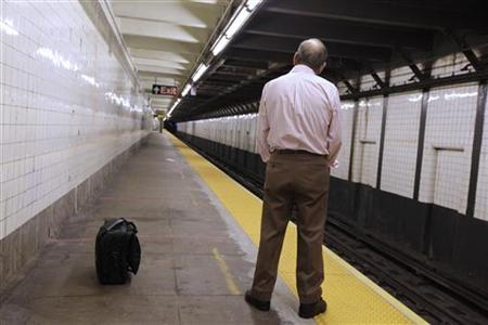 A man waits for a New York City subway train before it is scheduled to close in Brooklyn A man waits for a New York City subway train before it is scheduled to close in Brooklyn