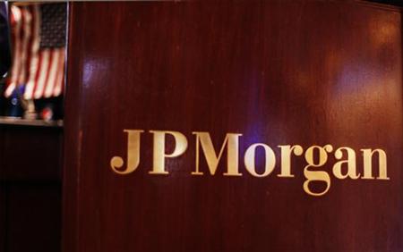 Flag hangs on the wall of the JP Morgan company stall on the floor of the New York Stock Exchange in New York Flag hangs on the wall of the JP Morgan company stall on the floor of the New York Stock Exchange in New York