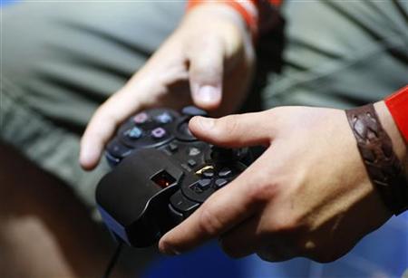 A visitor plays with a 'Playstation' at an exhibition stand at the Gamescom 2009 fair in Cologne A visitor plays with a 'Playstation' at an exhibition stand at the Gamescom 2009 fair in Cologne