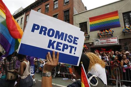 A participant in the Gay Pride Parade holds a sign reading, 'Promise Kept!' in reference to the recent legalization of gay marriage as they A participant in the Gay Pride Parade holds a sign reading, 'Promise Kept!' in reference to the recent legalization of gay marriage as they