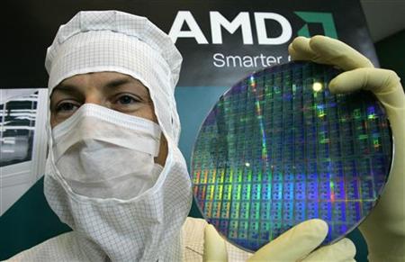 A technician of computer microprocessors maker AMD poses for the media with a wafer at the chip plant in Dresden A technician of computer microprocessors maker AMD poses for the media with a wafer at the chip plant in Dresden