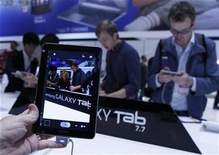 Man holds a Samsung Galaxy Tab 7.7 during press day at IFA consumer electronics fair in Berlin Man holds a Samsung Galaxy Tab 7.7 during press day at IFA consumer electronics fair in Berlin