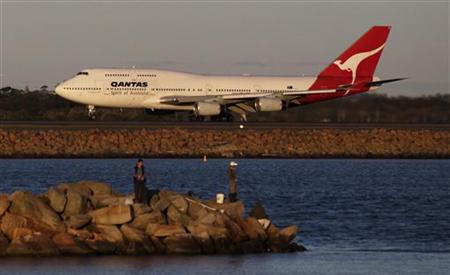 Qantas plane takes off at Sydney's airport as people fish near the runway in Sydney Qantas plane takes off at Sydney's airport as people fish near the runway in Sydney