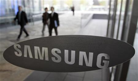 People walk behind a glass window bearing the logo of Samsung Electronics at the company's headquarters in Seoul People walk behind a glass window bearing the logo of Samsung Electronics at the company's headquarters in Seoul