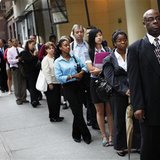 People wait in line to enter a job fair in New York