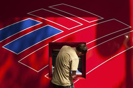 A Bank of America customer uses a Bank of America ATM in Charlotte A Bank of America customer uses a Bank of America ATM in Charlotte