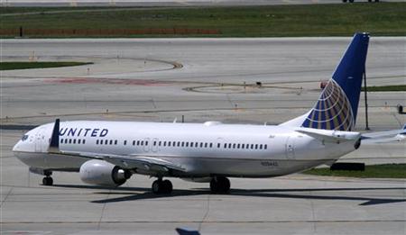 A United Airlines plane with the Continental Airlines logo on its tail, taxis to the runway at O'Hare International airport in Chicago A United Airlines plane with the Continental Airlines logo on its tail, taxis to the runway at O'Hare International airport in Chicago