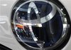 People are reflected on a Toyota Motor vehicle logo at the company showroom in Tokyo