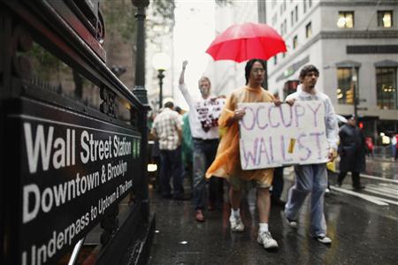 Demonstrators from the Occupy Wall Street campaign march past the entrance of a subway station in New York Demonstrators from the Occupy Wall Street campaign march past the entrance of a subway station in New York