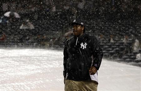 A groundskeeper is pictured during a rain delay in Game 1 of their MLB American League Division Series baseball playoffs between the Yankees A groundskeeper is pictured during a rain delay in Game 1 of their MLB American League Division Series baseball playoffs between the Yankees