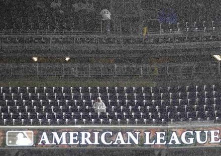 A New York Yankees fan waits during a rain delay in Game 1 of their MLB American League Division Series baseball playoffs against the Detroit Tigers in New York, September 30, 2011. REUTERS A New York Yankees fan waits during a rain delay in Game 1 of their MLB American League Division Series baseball playoffs against the Detroit Tigers in New York, September 30, 2011. REUTERS