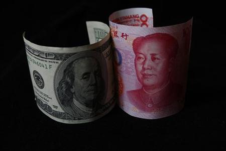 A 100 yuan banknote is placed next to a $100 banknote in this picture illustration taken in Beijing A 100 yuan banknote is placed next to a $100 banknote in this picture illustration taken in Beijing