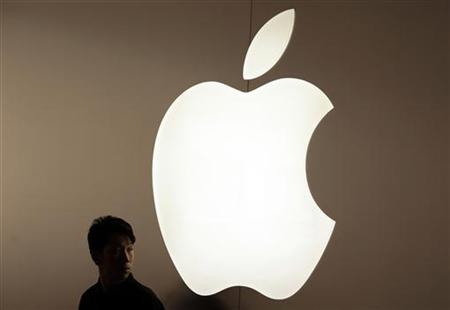A security guard stands in front of an Apple logo during the inauguration of the company's new store in Nanjing Road, Shanghai A security guard stands in front of an Apple logo during the inauguration of the company's new store in Nanjing Road, Shanghai
