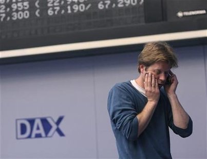 A trader uses his cell phone on the trading floor of Frankfurt stock exchange in Frankfurt A trader uses his cell phone on the trading floor of Frankfurt stock exchange in Frankfurt