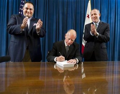 California Gov. Jerry Brown signs the state budget at the state Capitol in Sacramento, California California Gov. Jerry Brown signs the state budget at the state Capitol in Sacramento, California
