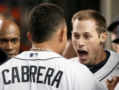 Detroit Tigers' Don Kelly (R) celebrates with teammate Miguel Cabrera after scoring in the sixth inning of Game 3 in their MLB American League Division Series baseball playoffs in Detroit, Michigan, October 3, 2011. REUTERS/Rebecca Cook (UNITED STATES - Tags: SPORT BASEBALL)