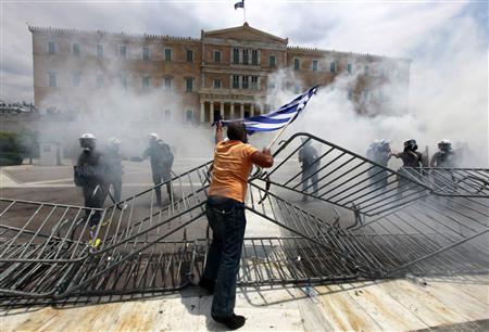 A protester taunts police in front of the parliament during violent protests in Athens' Syntagma square A protester taunts police in front of the parliament during violent protests in Athens' Syntagma square
