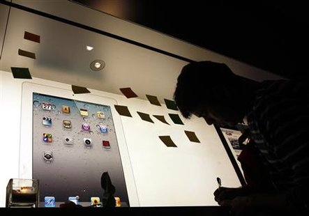 A man writes a note outside the Apple store in Hong Kong A man writes a note outside the Apple store in Hong Kong