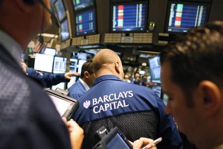 Traders gather at the Barclays Capital's kiosk on the floor of the New York Stock Traders gather at the Barclays Capital's kiosk on the floor of the New York Stock