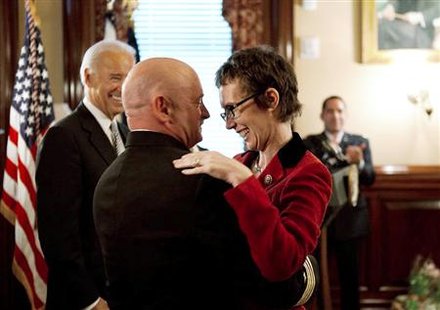 Captain Mark Kelly hugs his wife Gabrielle Giffords after receiving the Legion of Merit during Kelly's retirement ceremony in the Secretary Captain Mark Kelly hugs his wife Gabrielle Giffords after receiving the Legion of Merit during Kelly's retirement ceremony in the Secretary