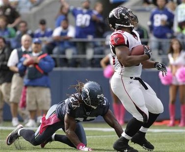Falcons' Turner breaks free from Seahawks' Bigby and runs for a 21-yard touchdown during their NFL football game in Seattle Falcons' Turner breaks free from Seahawks' Bigby and runs for a 21-yard touchdown during their NFL football game in Seattle