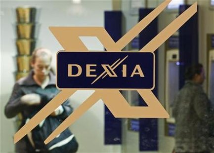 A woman walks inside a local branch of the Belgian-French financial services group Dexia in Brussels A woman walks inside a local branch of the Belgian-French financial services group Dexia in Brussels