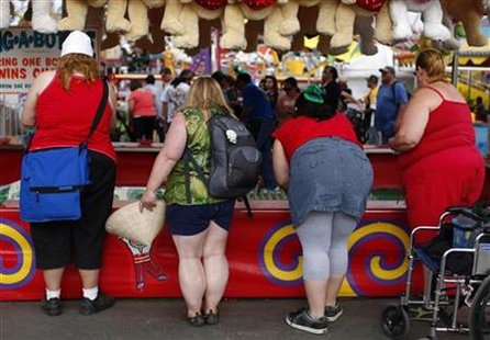 Fairgoers play a carnival game at the San Diego County Fair in Del Mar, California Fairgoers play a carnival game at the San Diego County Fair in Del Mar, California