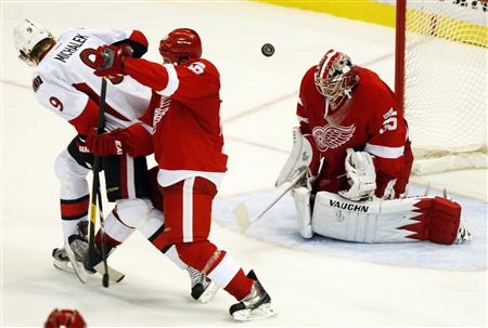 Ottawa Senators left wing Milan Michalek watches his shot fly past Detroit Red Wings defenseman Ian White and over goalie Jimmy Howard to sc Ottawa Senators left wing Milan Michalek watches his shot fly past Detroit Red Wings defenseman Ian White and over goalie Jimmy Howard to sc