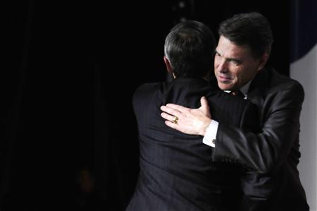 Perry hugs his presenter as he takes the stage to address the Family Research Council's Values Voters Summit in Washington Perry hugs his presenter as he takes the stage to address the Family Research Council's Values Voters Summit in Washington