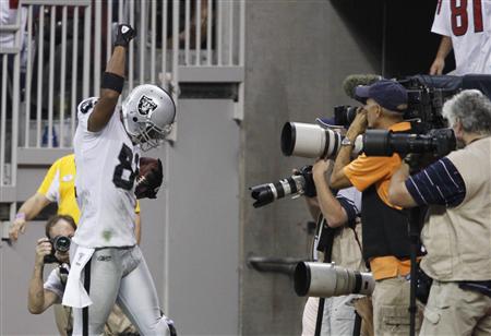Oakland Raiders' Schilens raises his fist in celebration in the end zone after scoring a touchdown against the Houston Texans during their N Oakland Raiders' Schilens raises his fist in celebration in the end zone after scoring a touchdown against the Houston Texans during their N