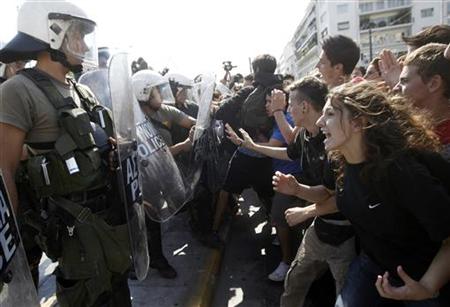 High-school students clash with riot police during a protest march against economic austerity and planned education reforms in Athens High-school students clash with riot police during a protest march against economic austerity and planned education reforms in Athens