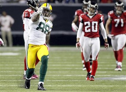Packers tight end Finley celebrates a first down in front of Atlanta Falcons defense in the second half of their NFL football game against t Packers tight end Finley celebrates a first down in front of Atlanta Falcons defense in the second half of their NFL football game against t