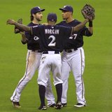 Milwaukee Brewers left fielder Ryan Braun (L), right fielder Nyjer Morgan (C) and center fielder Carlos Gomez celebrate after defeating the St. Louis Cardinals in Game 1 of the MLB National League Championship Series baseball playoffs in Milwaukee, October 9, 2011. REUTERS/Darren Hauck Milwaukee Brewers left fielder Ryan Braun (L), right fielder Nyjer Morgan (C) and center fielder Carlos Gomez celebrate after defeating the St. Louis Cardinals in Game 1 of the MLB National League Championship Series baseball playoffs in Milwaukee, October 9, 2011. REUTERS/Darren Hauck