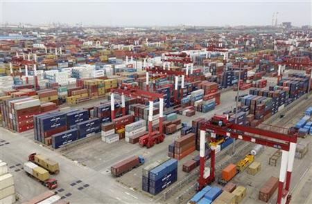 Trucks are driven into a shipping container area at Qingdao port Trucks are driven into a shipping container area at Qingdao port