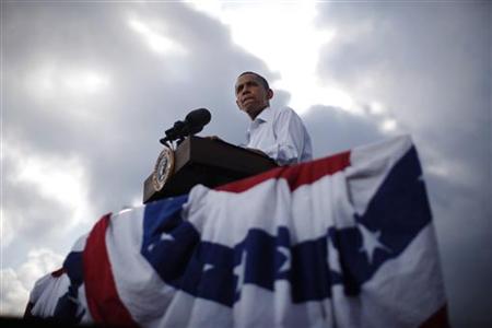 President Barack Obama is pictured as the sun breaks through clouds at a town hall-style event in Alpha President Barack Obama is pictured as the sun breaks through clouds at a town hall-style event in Alpha