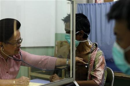 Doctor Marion Aritonang checks the lungs of a newly diagnosed tuberculosis patient at the Indonesian Union Against Tuberculosis clinic in Ja Doctor Marion Aritonang checks the lungs of a newly diagnosed tuberculosis patient at the Indonesian Union Against Tuberculosis clinic in Ja