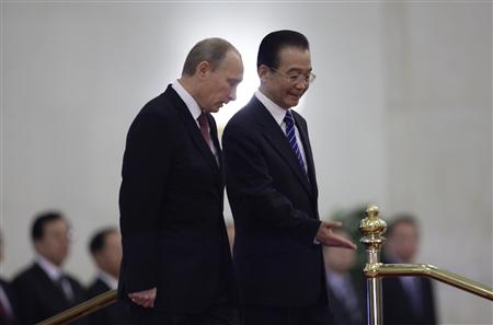 China's Premier Wen gestures next to Russia's Prime Minister Putin during a welcome ceremony at the Great Hall of the People in Beijing China's Premier Wen gestures next to Russia's Prime Minister Putin during a welcome ceremony at the Great Hall of the People in Beijing